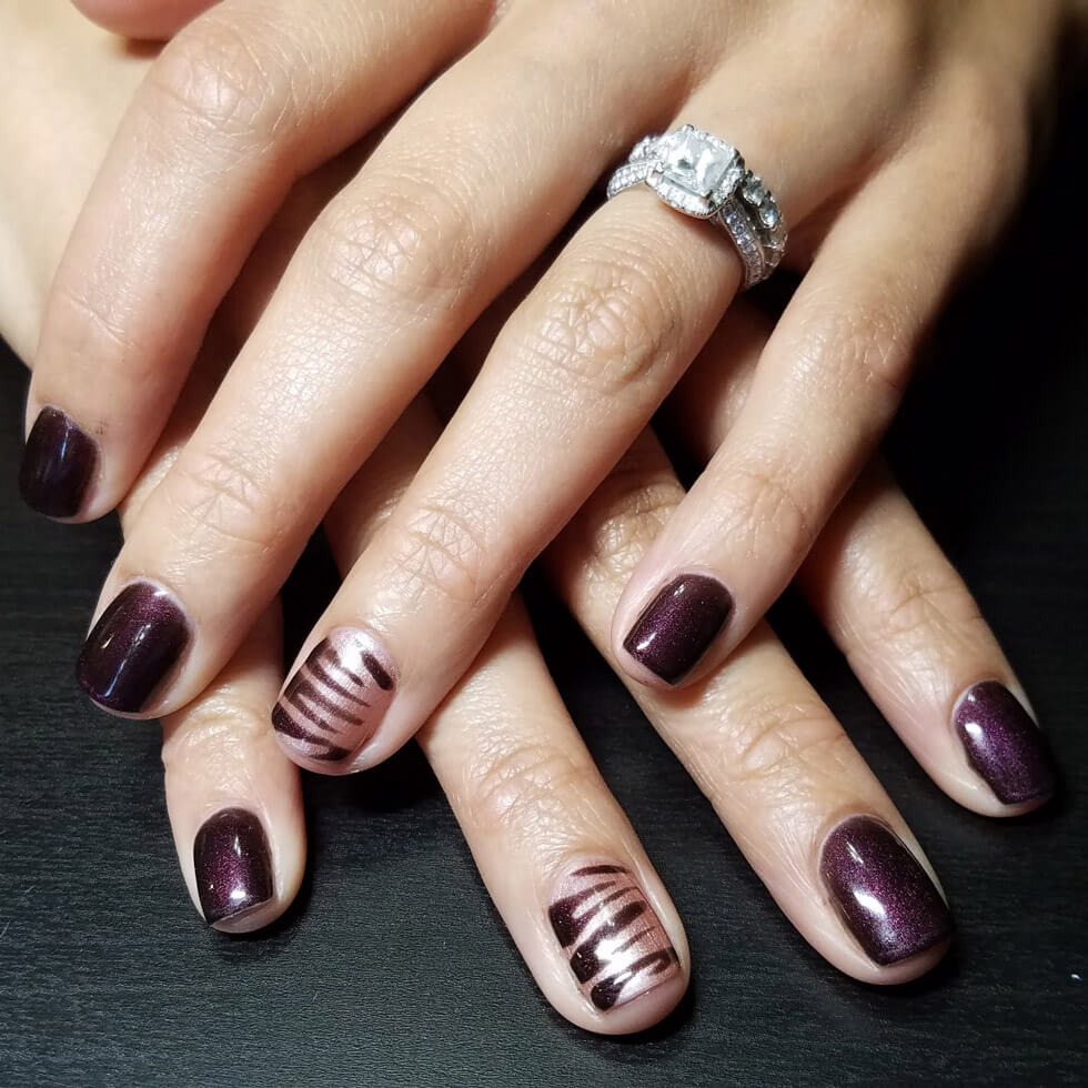 burgundy and zebra painted manicure